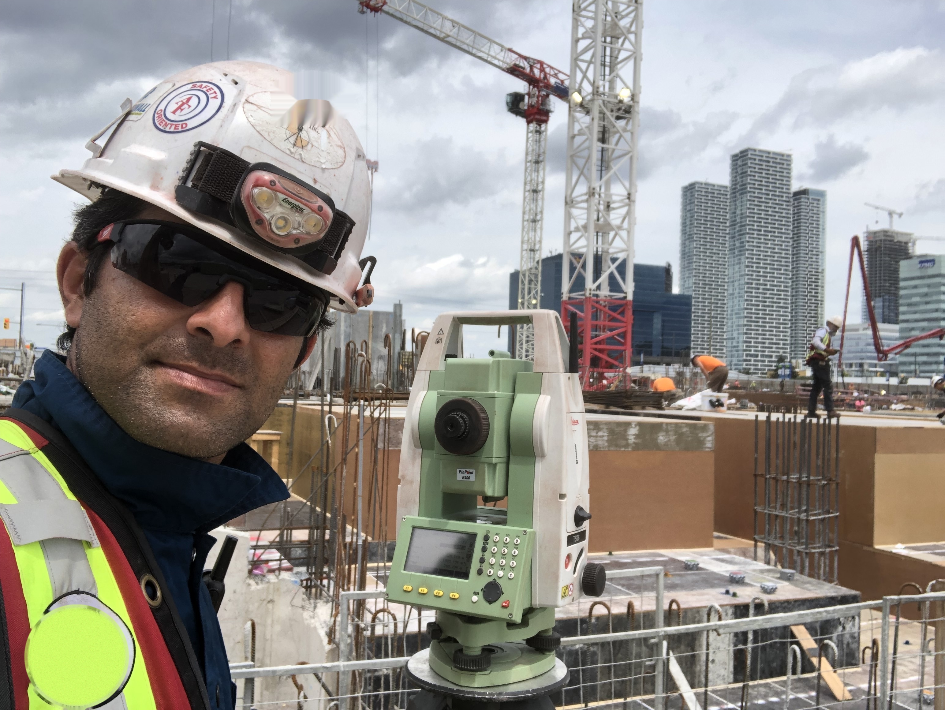 Mehdi Momenzadeh, P.Eng. with a total station on a GTA construction site