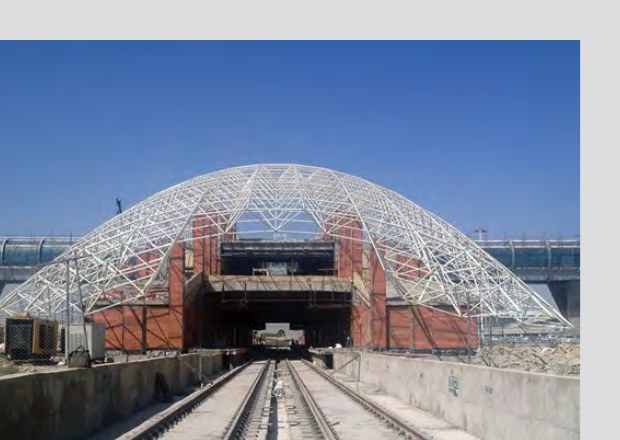 White space-frame canopy at an airport railway station under construction