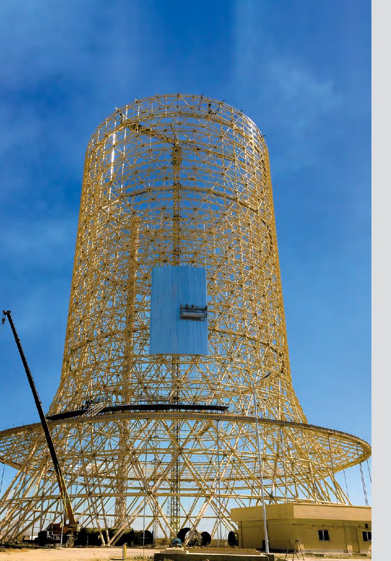 Yellow steel space-frame cooling tower under construction